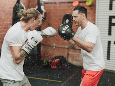 A coach working with boxers at a UK boxing club running on ClubRight