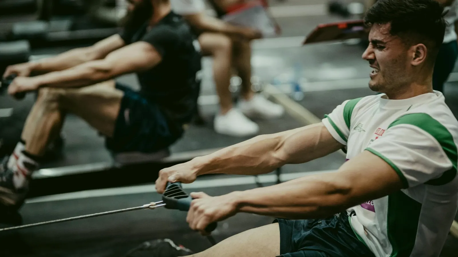 A gym member uses a rowing machine as part of a HYROX training class they signed up for after getting a message from the gym reminding them to come in.
