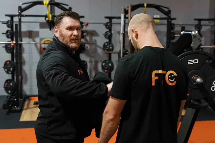 An FTC coach working with a member during a session