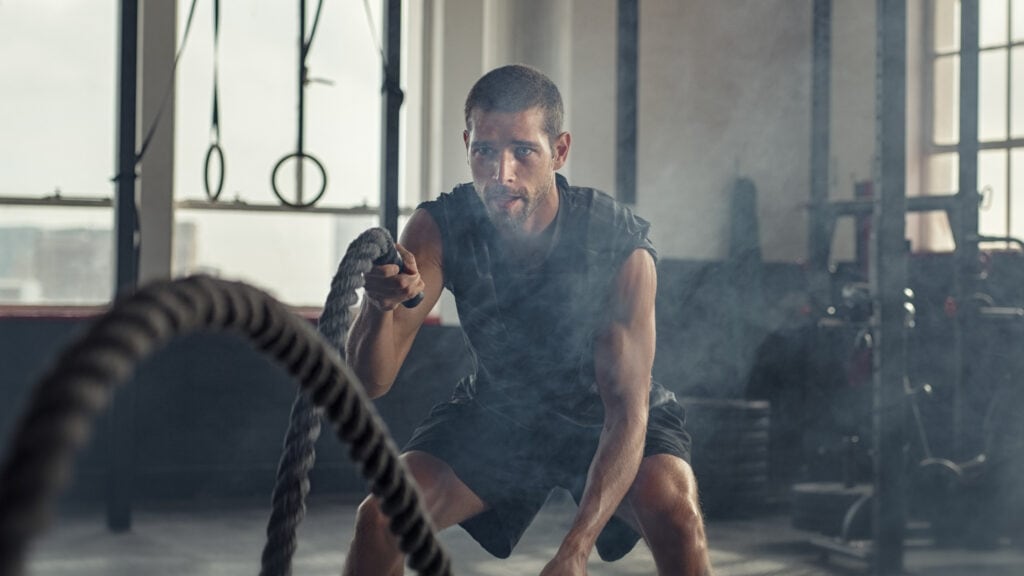 A gym owner exercises using battle ropes after coming up with a strategy to capitalise on the predicted fitness trends for 2025.