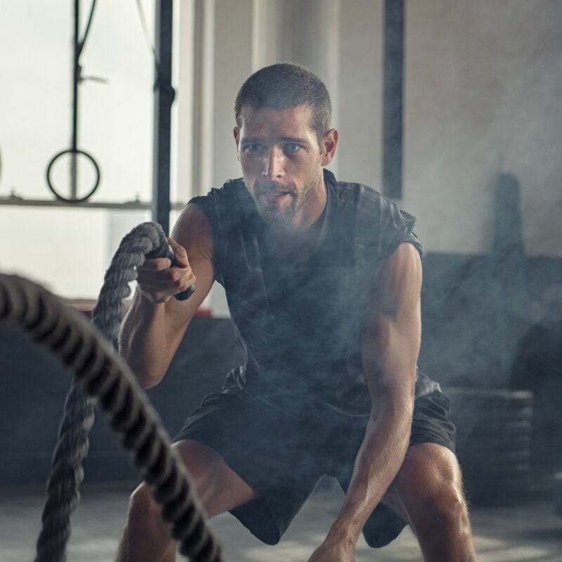 A gym owner exercises using battle ropes after coming up with a strategy to capitalise on the predicted fitness trends for 2025.