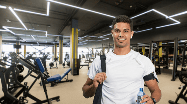a happy male gym user showing the benefits of having a gym management software