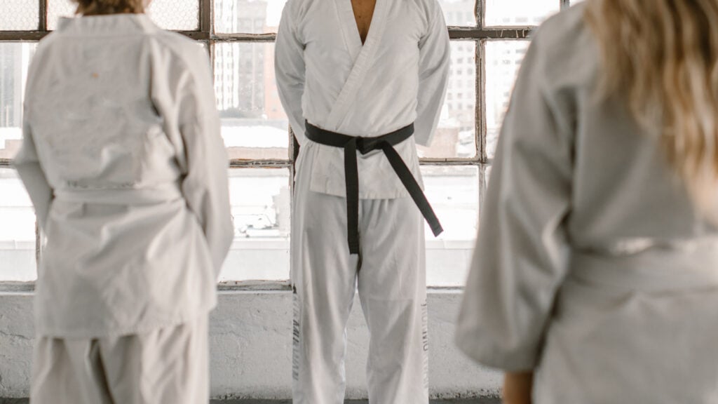 Martial Arts instructor stands in front of a class of new students following a successful branding campaign.