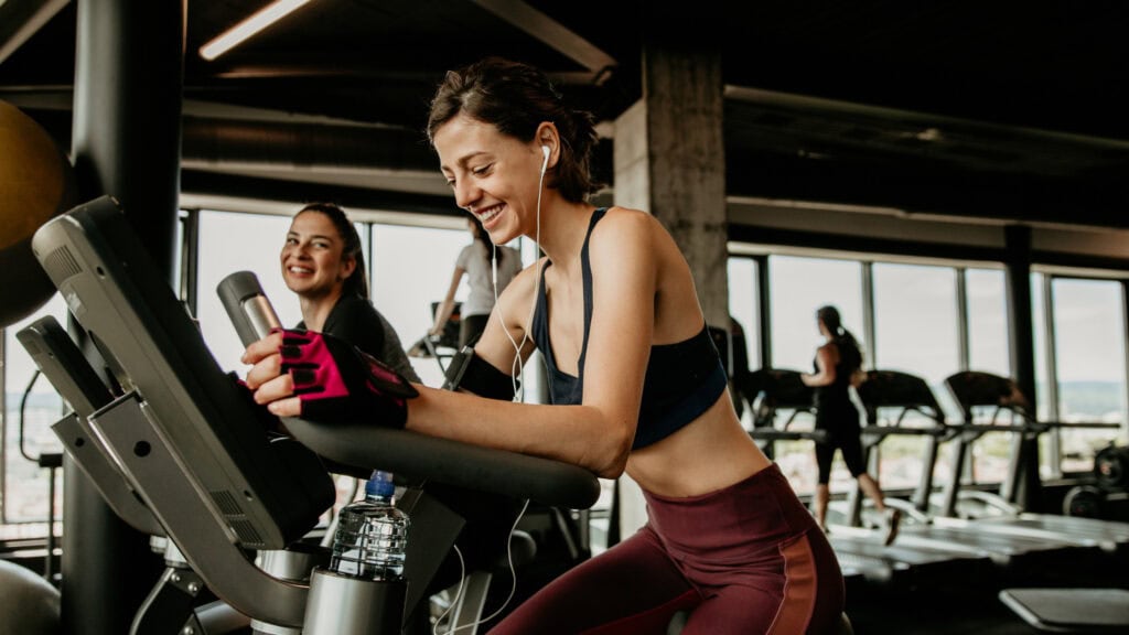 Woman exercises on a crosstrainer after joining a new gym from their ‘third space’ campaign.
