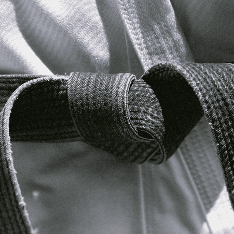 Martial arts student tightens belt after arriving at a booked-out class.