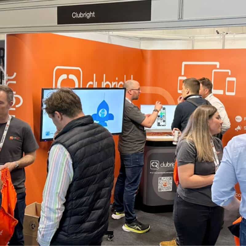 The ClubRight Team at Elevate chatting with friends, customers, and partners.