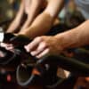 Man exercises in spin class after booking his favourite spot at the front of the class.