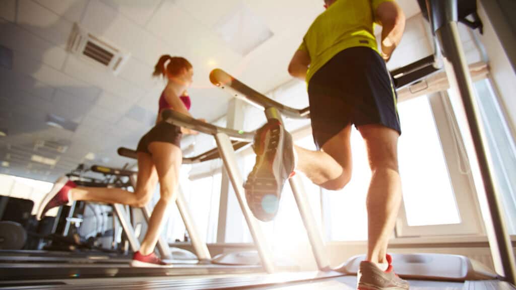 Two new members run on treadmills after beginning to feel more confident and comfortable at their new gym.
