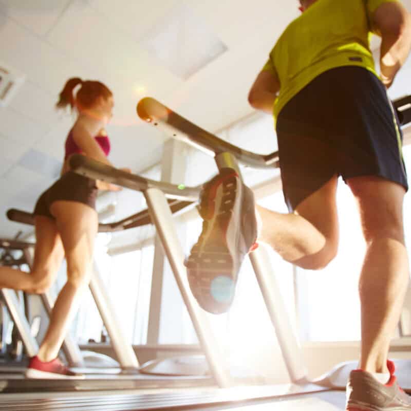 Two new members run on treadmills after beginning to feel more confident and comfortable at their new gym.