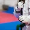 A new student at a martial arts club prepares for their first session after instructors helped boost their confidence.