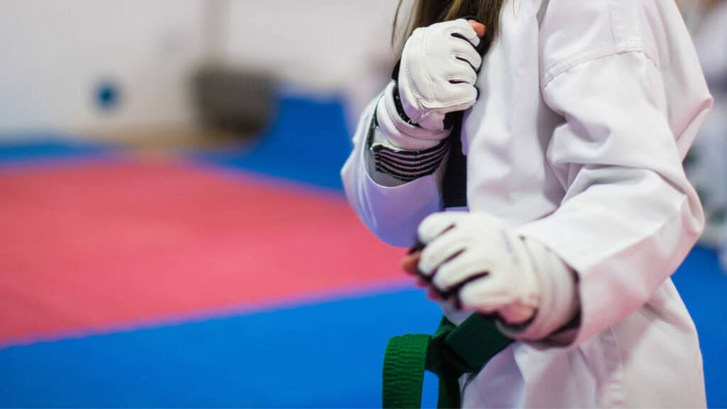 A new student at a martial arts club prepares for their first session after instructors helped boost their confidence.