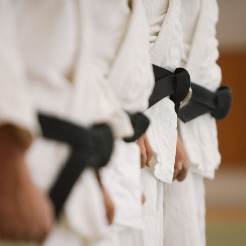 Martial arts club instructors prepare for a new class after reviewing their member behaviour data.