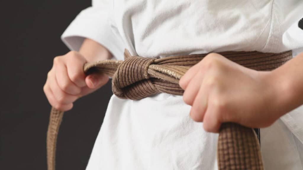 Karate student prepares for their first martial arts class after successfully moving through the club’s sales funnel.
