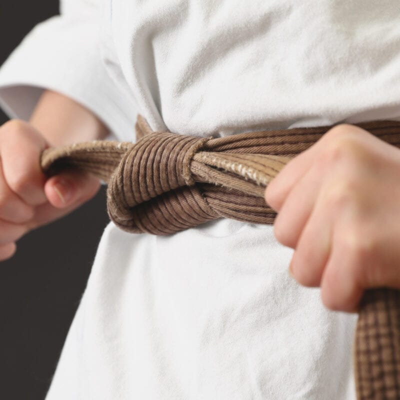 Karate student prepares for their first martial arts class after successfully moving through the club’s sales funnel.