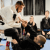 Martial arts instructor teaches jujitsu class after successfully streamlining their school’s operations.