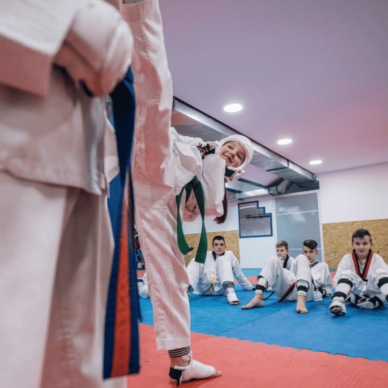Long-time students participate in a belt-grading exercise at a martial arts club.