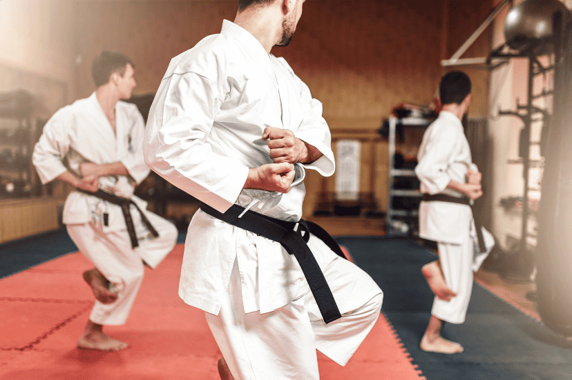 A martial arts instructor and two students training in a sports club while experimenting with different ways martial arts clubs can promote themselves online